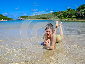 Woman sunbathing in lagoon