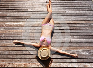 Woman sunbathing lying at deck