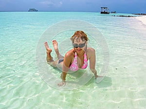 Woman sunbathing in Maldives lagoon