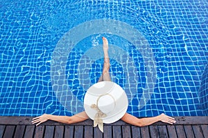 Woman sunbathing by the pool