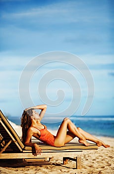 Woman sunbathing on a sunbed