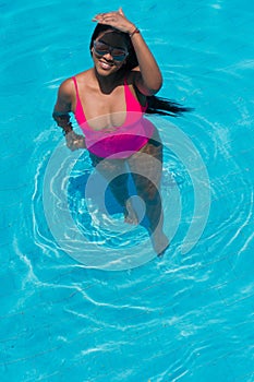 Woman sunbathing at a tropical vacation party. Cute black woman under the sun