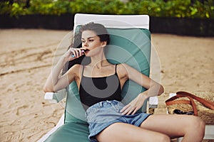 woman sunbed ocean sun sand smiling beach lying lifestyle resort sea