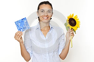 Woman with sunflower and solar cell