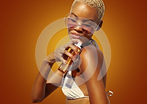 woman with sunglasses applying sunscreen lotion to shoulder skin for care and sun protection,  on orange color background