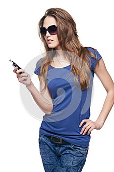 Woman in sunglasses dialing her cell phone