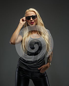 Woman in sunglasses with long blond hair.