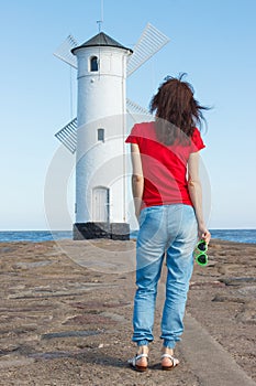 Woman with sunglasses in shape of heart on west breakwater in Swinoujscie