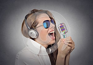 Woman with sunglasses singing with microphone