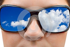Woman in sunglasses and sky reflection
