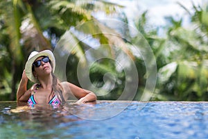 Woman sunglasses sunbathe tropical swimming pool