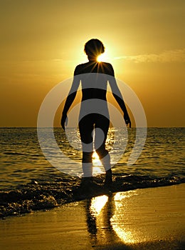 Woman at sunrise with sun in head