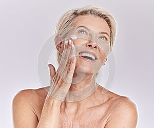 Woman with sunscreen on face for beauty skincare, showing cosmetics with smile and care for skin wellness standing on