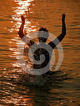 Woman at sunset in sea