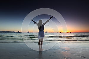 Woman at sunset by the sea