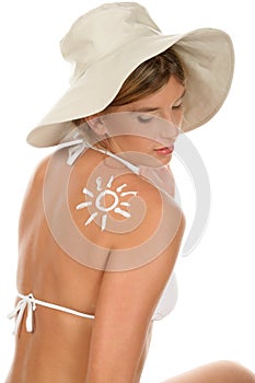 Woman with suntan lotion photo