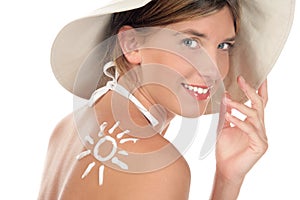 Woman with suntan lotion photo