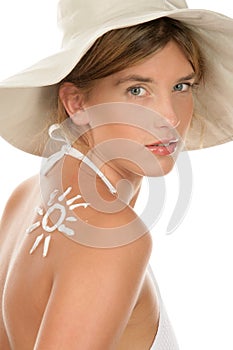 Woman with suntan lotion photo