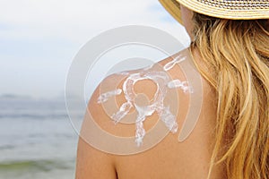 Woman with suntan lotion at the beach photo