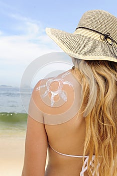 Woman with suntan lotion at the beach photo