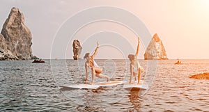 Woman sup yoga. Happy sporty woman practising yoga pilates on paddle sup surfboard. Female stretching doing workout on