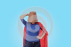 Woman superhero with a red cape and a flower pot on her head