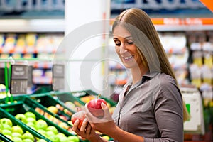 Woman in supermarket shopping groceries