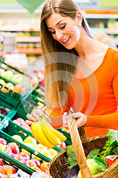 Woman in supermarket shopping groceries