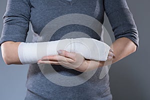 Woman support her hand in bandage