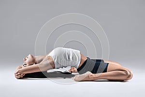 Woman in supta virasana yoga position