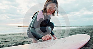 Woman, surfboard wax and happy at beach, thinking and ready for workout, training or wellness in morning. Person, surfer