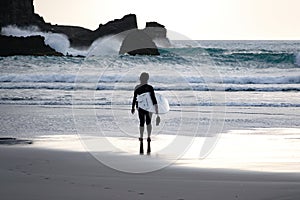 Woman surfer in black wetsuit