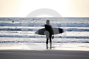 Woman surfer in black wetsuit