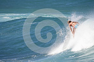 Woman surfer enjoys riding waves