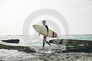 Woman surfer with surfboard