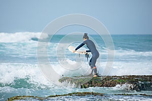 Woman surfer with surfboard