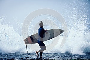 Woman surfer with surfboard