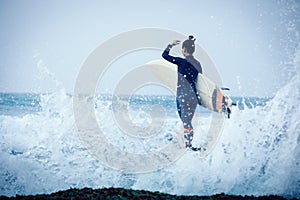 Woman surfer with surfboard