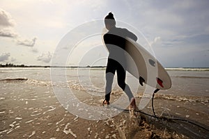 Woman surfer with white surfboard