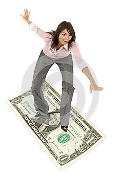 Woman surfing on dollar banknote