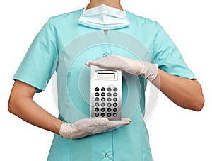 Woman surgeon holding a calculator