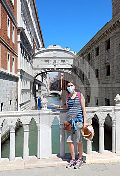 Woman with surgical mask and the Bridge of Sighs in Venice