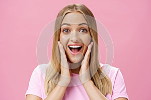 Woman surprised to see own face without imperfactions treating acne feeling beautiful and happy touching cheeks, smiling