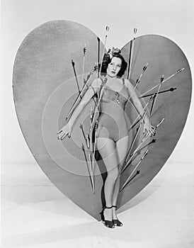 Woman surrounded by arrows on huge heart photo