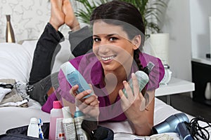 Woman surrounded by cosmetics