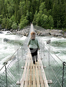 Woman on suspension bridge