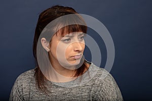 Woman with a suspicious look on blue background