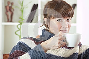 Woman in sweater drinking tea