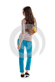 Woman in sweater looking back.