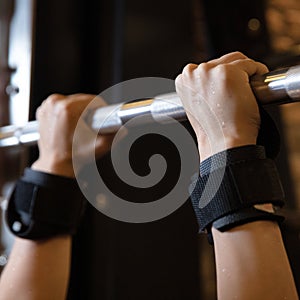 Woman sweaty hands, execute exercise on horizontal bar in gym
